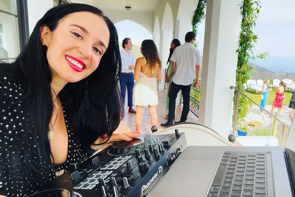 Jackie at her Pioneer DJ controller on a Malibu villa terrace.