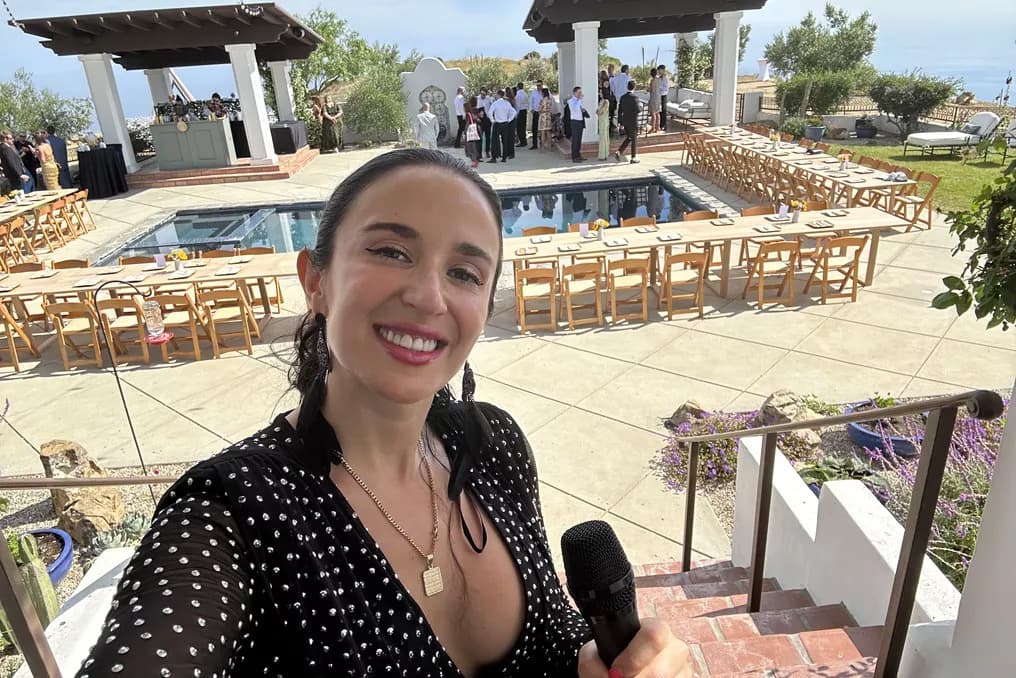 Pool-side wedding ceremony at a Malibu villa with rows of wedding chairs and oceanview